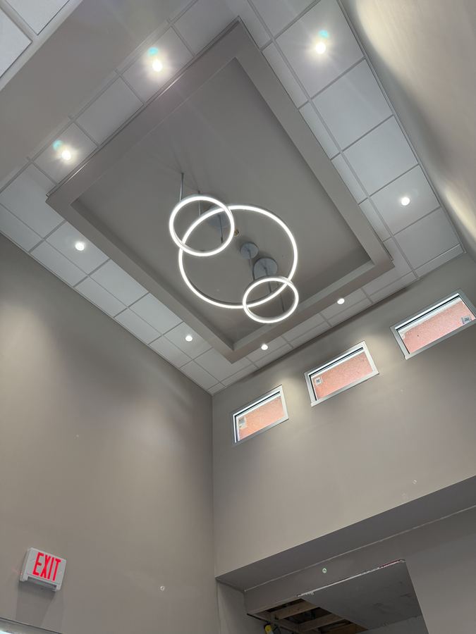 Finished commercial ceiling with recessed lighting and a feature pendant
